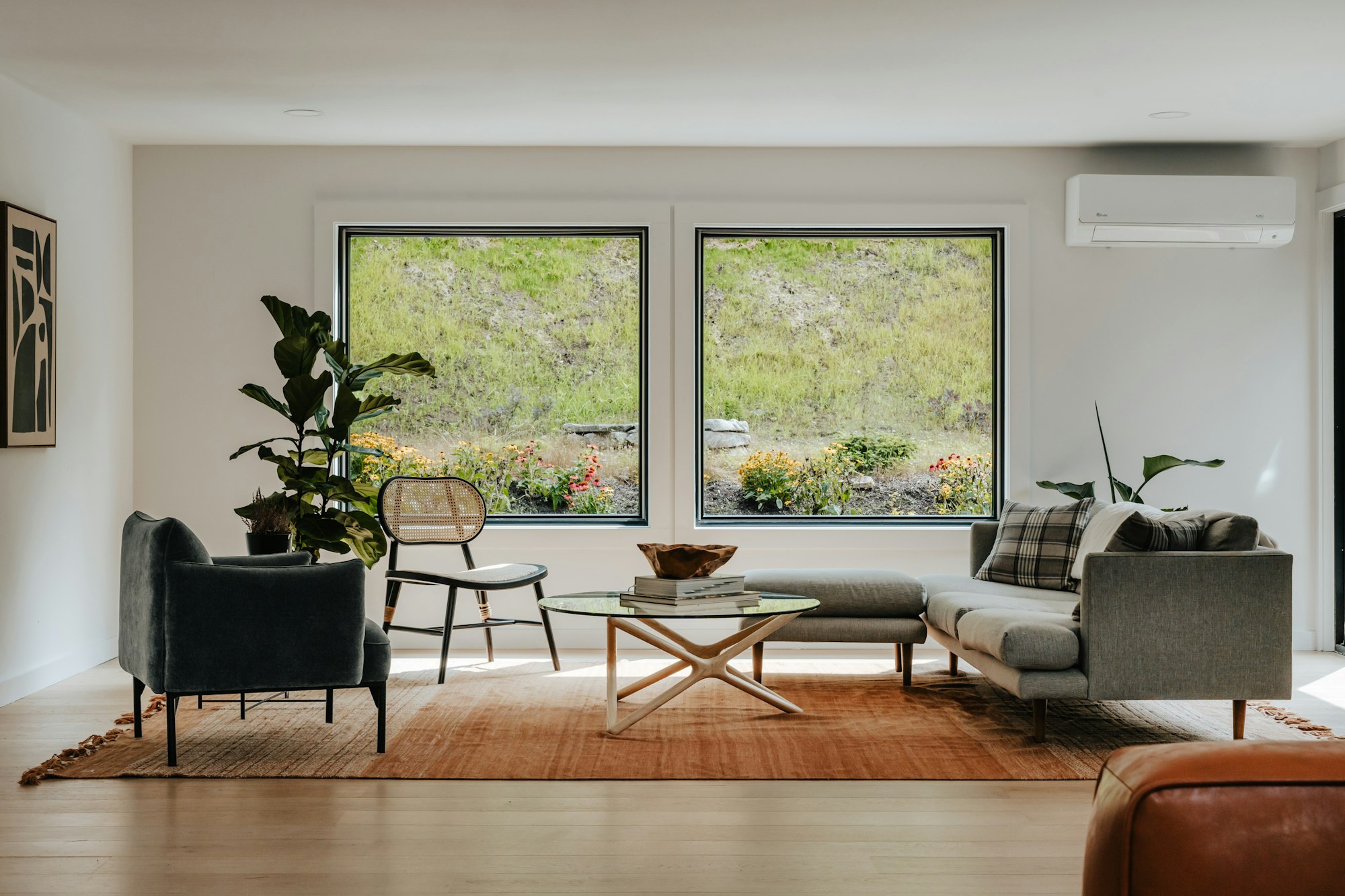 Bright living room with large black-framed picture windows